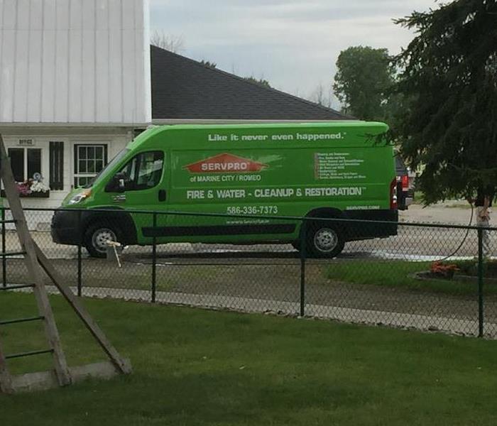SERVPRO of Marine City/Romeo vehicle parked in front of office on a stormy day.